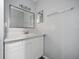 This bathroom showcases a vanity with a marble countertop, white cabinets, and a chrome faucet at 4215 S Semoran Blvd # 15, Orlando, FL 32822