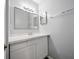 This bathroom features a vanity with marble countertops, double mirrors, and white cabinets at 4215 S Semoran Blvd # 15, Orlando, FL 32822
