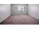 The bedroom features neutral colored walls and carpet with a window that provides natural light into the space at 4215 S Semoran Blvd # 15, Orlando, FL 32822