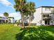 A charming exterior view shows the building's facade, set against a backdrop of palm trees and a grassy lawn at 4215 S Semoran Blvd # 15, Orlando, FL 32822