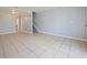 Bright living room with neutral tones, tile floors, and a view of the staircase, ideal for relaxation and entertaining guests at 4215 S Semoran Blvd # 15, Orlando, FL 32822