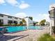 Resort-style community pool with ample seating and a lush landscape, perfect for relaxation and recreation under blue skies at 4215 S Semoran Blvd # 15, Orlando, FL 32822