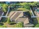 Aerial view showcasing the home's layout and roof and the fully fenced-in backyard at 506 Alleria Ct, Auburndale, FL 33823