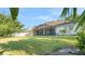 Spacious backyard featuring a large screened-in lanai with ample room for entertaining and a lush green lawn at 506 Alleria Ct, Auburndale, FL 33823