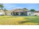 Lush backyard featuring a screened-in lanai perfect for outdoor relaxation and entertaining on a well-maintained lawn at 506 Alleria Ct, Auburndale, FL 33823