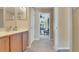 Neutral bathroom with vanity and access to outdoor porch area with ceiling fans at 506 Alleria Ct, Auburndale, FL 33823