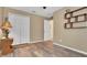 Bedroom with wood-look flooring, closet, and neutral paint at 506 Alleria Ct, Auburndale, FL 33823