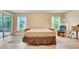 Bright bedroom showcases wood-look flooring, sliding glass doors, and neutral tones at 506 Alleria Ct, Auburndale, FL 33823