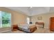 Inviting bedroom with wood-look floors, natural light, and ceiling fan at 506 Alleria Ct, Auburndale, FL 33823