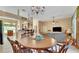 Open-concept dining area flows seamlessly into the living room and kitchen with breakfast bar at 506 Alleria Ct, Auburndale, FL 33823