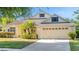 Beautiful home featuring a well-kept lawn, vibrant landscaping, and a spacious two-car garage at 506 Alleria Ct, Auburndale, FL 33823