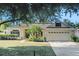 Well-maintained home with a lush front lawn, established landscaping, and a convenient two-car garage at 506 Alleria Ct, Auburndale, FL 33823