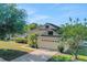 Charming home featuring a spacious driveway, well-maintained lawn, and mature trees providing shade at 506 Alleria Ct, Auburndale, FL 33823