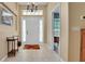 Welcoming foyer with chandelier, tile flooring and front door with sidelights at 506 Alleria Ct, Auburndale, FL 33823