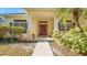 Inviting entrance featuring a covered porch, decorative columns, and meticulously maintained landscaping at 506 Alleria Ct, Auburndale, FL 33823