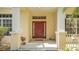 Welcoming front entrance with a covered porch, elegant columns, and lovely landscaping at 506 Alleria Ct, Auburndale, FL 33823