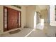 Inviting front entry features a covered porch and classic wood door with sidelights at 506 Alleria Ct, Auburndale, FL 33823