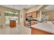 Bright kitchen featuring a corner sink, stainless steel appliances, and natural wood cabinets at 506 Alleria Ct, Auburndale, FL 33823