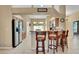 Open concept kitchen with stainless steel refrigerator, breakfast bar, and tile flooring at 506 Alleria Ct, Auburndale, FL 33823