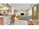 Open-concept space with kitchen, bar, and dining area connected to living room at 506 Alleria Ct, Auburndale, FL 33823