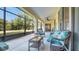 Covered patio with wicker furniture, ceiling fan, and screened-in porch at 506 Alleria Ct, Auburndale, FL 33823