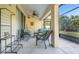 Relaxing covered patio with wicker seating, ceiling fan, and views of the garden at 506 Alleria Ct, Auburndale, FL 33823