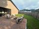 Backyard patio with seating area, privacy fence, and grassy lawn at 5719 Sweetheart Ct, St Cloud, FL 34772
