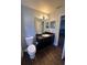Bathroom featuring modern light fixture, wood-look floors, and sleek vanity at 5719 Sweetheart Ct, St Cloud, FL 34772