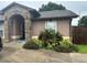 Charming single-story home features a stone archway entrance and mature landscaping, enhancing its curb appeal at 5719 Sweetheart Ct, St Cloud, FL 34772