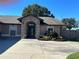 Inviting exterior showcasing the stone arch entryway and well-manicured landscaping of this lovely home at 5719 Sweetheart Ct, St Cloud, FL 34772