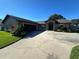 Inviting single-Gathering home with a spacious driveway and well-maintained lawn under a clear blue sky at 5719 Sweetheart Ct, St Cloud, FL 34772