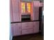 Kitchen featuring pink cabinets with under cabinet lights and stainless steel refrigerator at 5719 Sweetheart Ct, St Cloud, FL 34772
