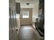 Functional laundry room with storage cabinets, utility sink, and modern flooring at 5719 Sweetheart Ct, St Cloud, FL 34772