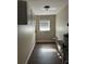 This laundry room features wood-look floors, upper cabinets, and a window for natural light at 5719 Sweetheart Ct, St Cloud, FL 34772