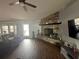 Inviting living room with stone fireplace, wood floors, and plenty of natural light at 5719 Sweetheart Ct, St Cloud, FL 34772
