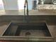 Kitchen featuring a dark sink and counter, complemented by pink cabinets at 5719 Sweetheart Ct, St Cloud, FL 34772