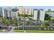 Aerial view of a condominium complex featuring a swimming pool and parking at 6165 Carrier Dr # 1603, Orlando, FL 32819
