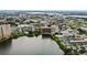Impressive aerial view showcasing complex, lake, parking, & surrounding buildings at 6165 Carrier Dr # 1603, Orlando, FL 32819