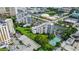 Wide aerial view displays multiple buildings, parking lots, manicured lawns, and tennis court at 6165 Carrier Dr # 1603, Orlando, FL 32819