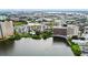 Majestic aerial view of buildings on a lake highlighting nearby parking and structures at 6165 Carrier Dr # 1603, Orlando, FL 32819
