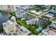 Expansive aerial view displays community, parking, tennis court, landscaping, and nearby highway at 6165 Carrier Dr # 1603, Orlando, FL 32819