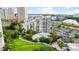 Breathtaking aerial view showcases building, outdoor pool, lush lawns, and ample parking at 6165 Carrier Dr # 1603, Orlando, FL 32819