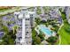 Aerial view of condo complex showcasing pool, lush landscaping, and ample parking at 6165 Carrier Dr # 1603, Orlando, FL 32819