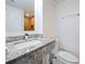 Bathroom features granite countertops, updated fixtures and wood-look tiled shower at 6165 Carrier Dr # 1603, Orlando, FL 32819