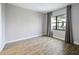 Neutral bedroom featuring wood-look tile flooring, gray walls and natural light from the window at 6165 Carrier Dr # 1603, Orlando, FL 32819