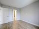 Bright bedroom with wood-look tile, closet, and ensuite bathroom for comfortable living at 6165 Carrier Dr # 1603, Orlando, FL 32819