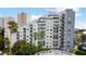 Attractive condo building featuring multiple balconies with a pool and landscaping at 6165 Carrier Dr # 1603, Orlando, FL 32819
