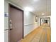 Hallway with neutral carpet, light walls, and the door of unit 1603 at 6165 Carrier Dr # 1603, Orlando, FL 32819
