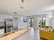 Open-concept condo featuring stainless appliances, breakfast bar, wood floors, and balcony access at 6165 Carrier Dr # 1603, Orlando, FL 32819