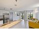 Living space showcasing a kitchen, living room with a sliding door to a balcony at 6165 Carrier Dr # 1603, Orlando, FL 32819